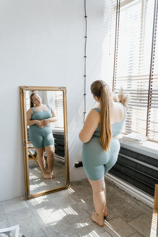 A woman looking at herself in the mirror