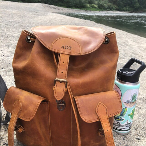 Leather Backpack on the beach in the sand for a summer beach side trip