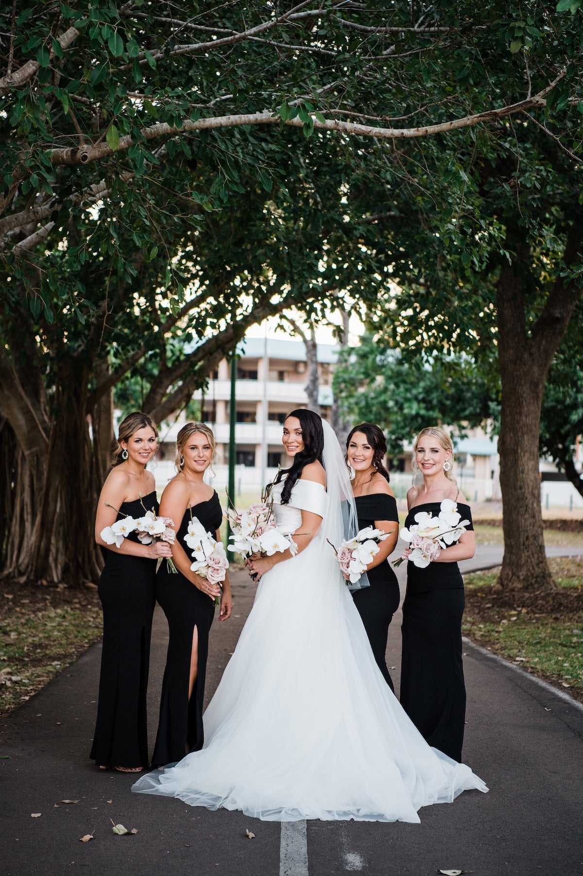 bride and bridesmaids with phalenopsis orchid bouquets