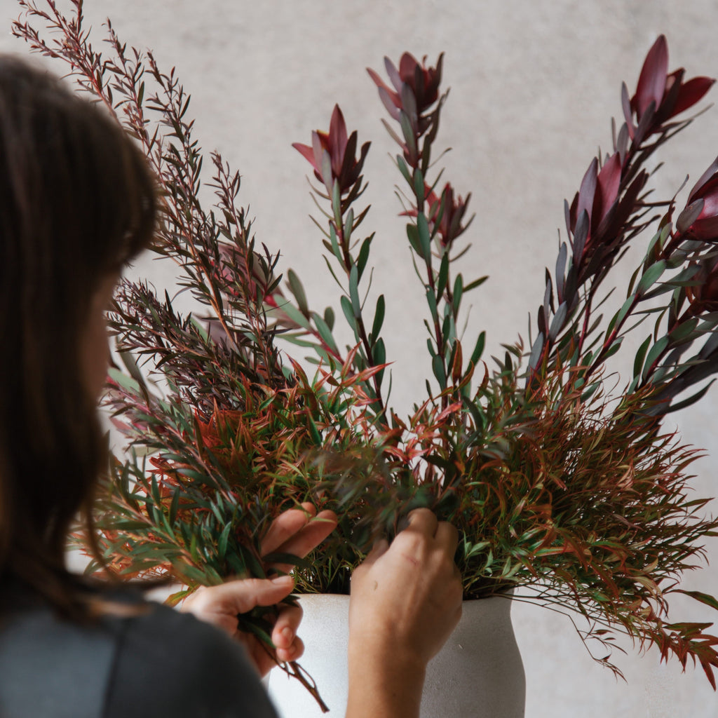 Maria Okwa Beija Flor's Owner and Creative Director arranging florals in a statement vase