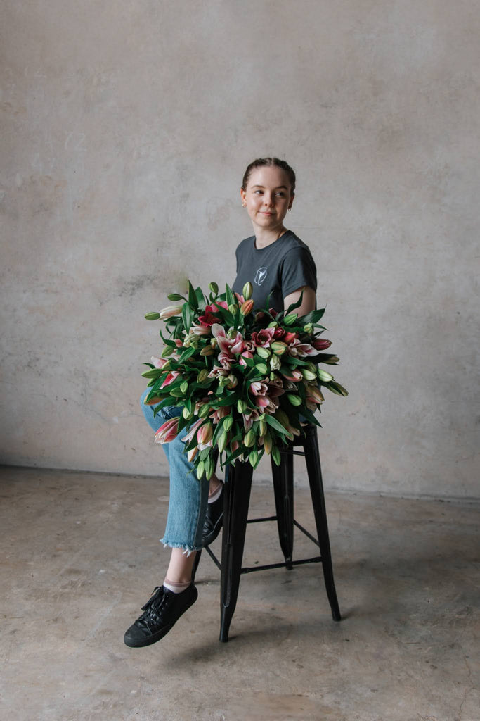 Mary Fryar Beija Flor Florist Sitting with Bunch of Tulips