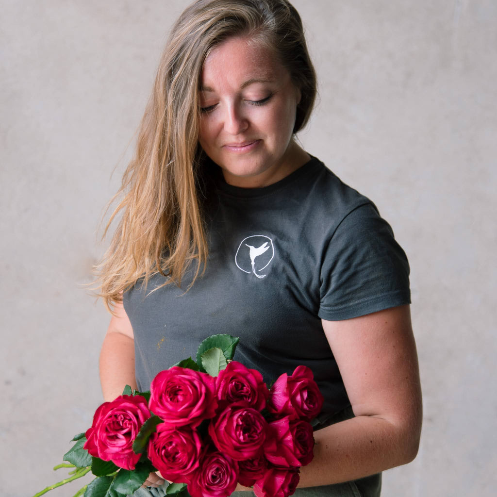 Meet the Beija Flor team Sarah - holding a bunch of rose