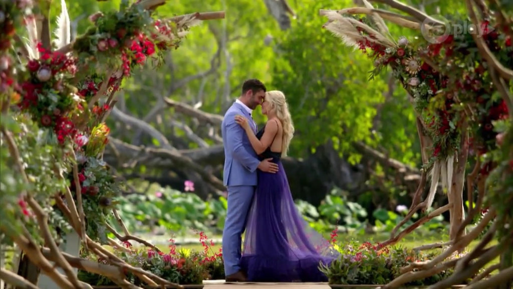 The Bachelorette finale the scene where Beau kissed Bec with a roses and fresh florals in the background