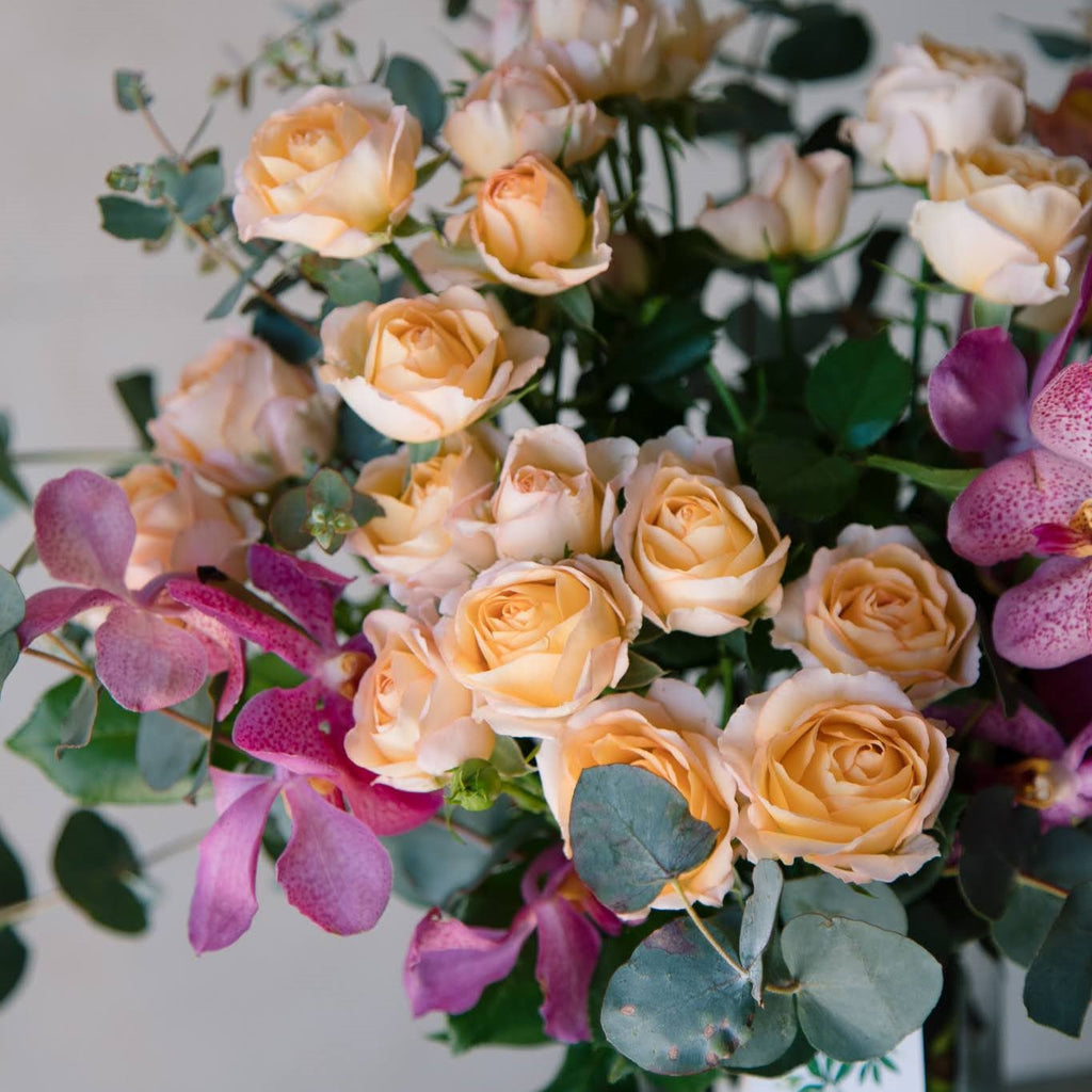 a bouquet of Peachy toned flowers and greeneries
