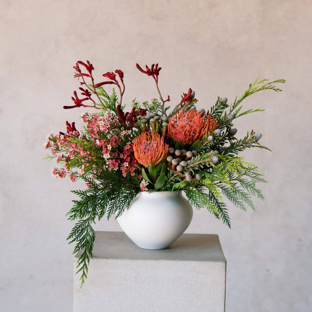 Beija Flor's Saltzburg vase filled with festive red flowers and foliage