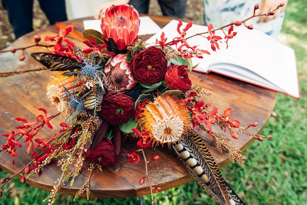 brides bouquet of banksia, protea and pheasant feathers for a bohemian inspired Darwin wedding