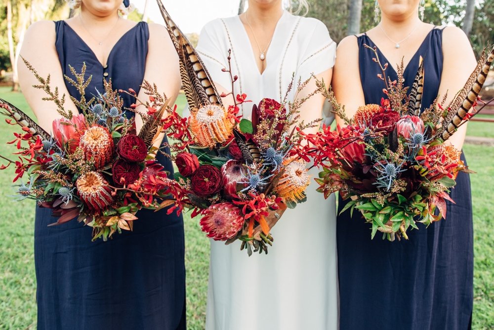 bride and bridesmaids bohemian inspired bouquets to complement navy dresses