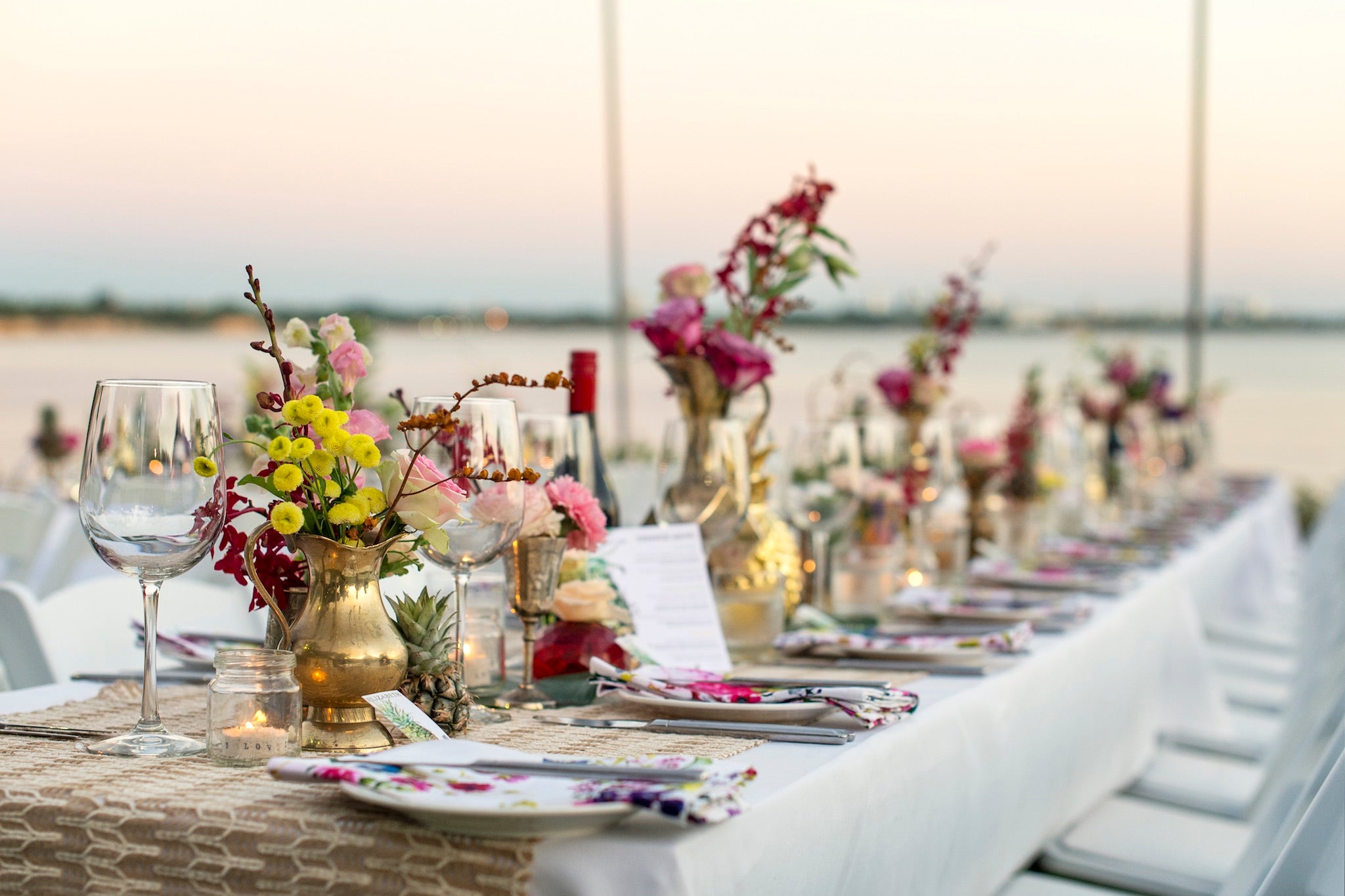 wedding guests enjoy sunset over Fannie Bay from Pee Wees lawns