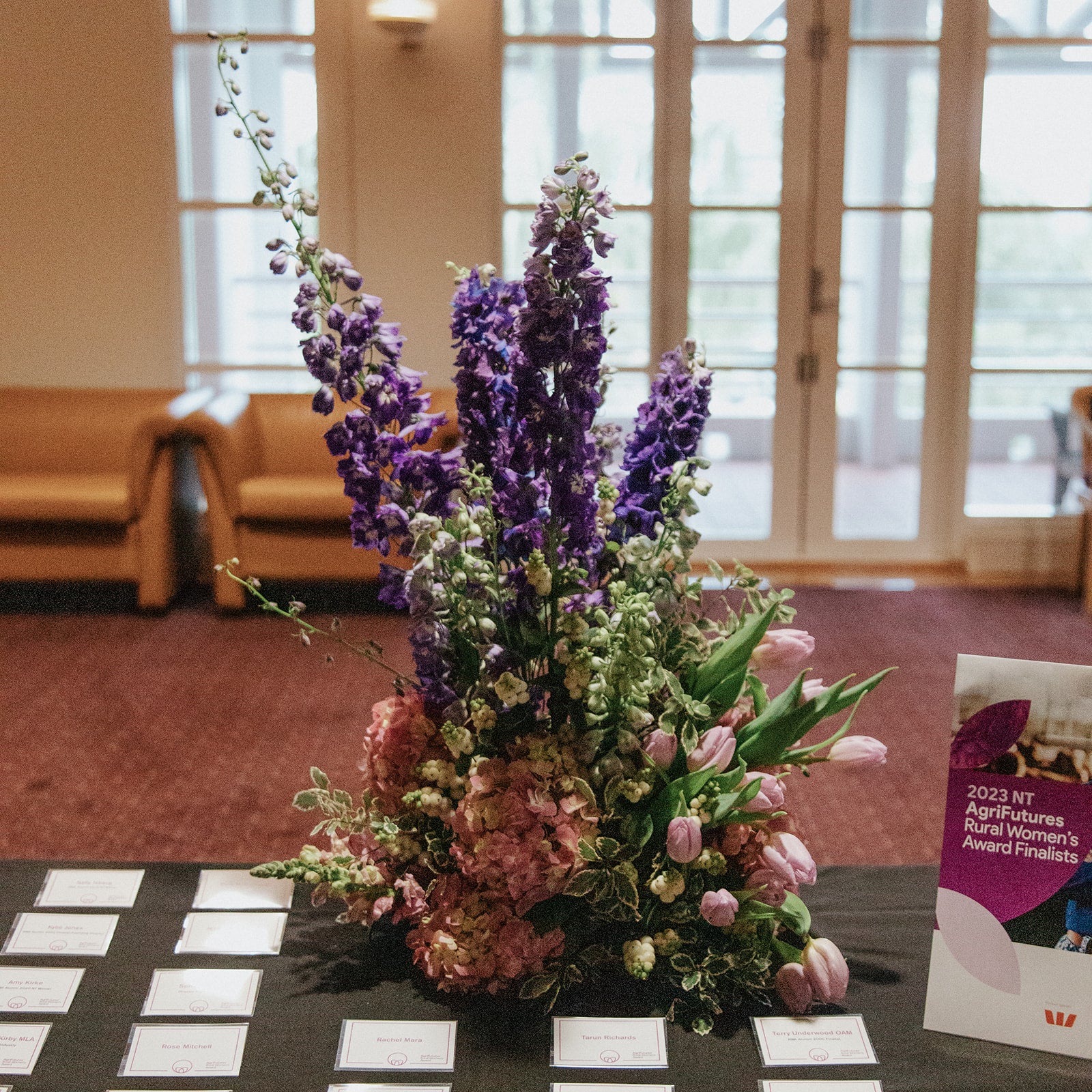 vase of flowers on a table with a book