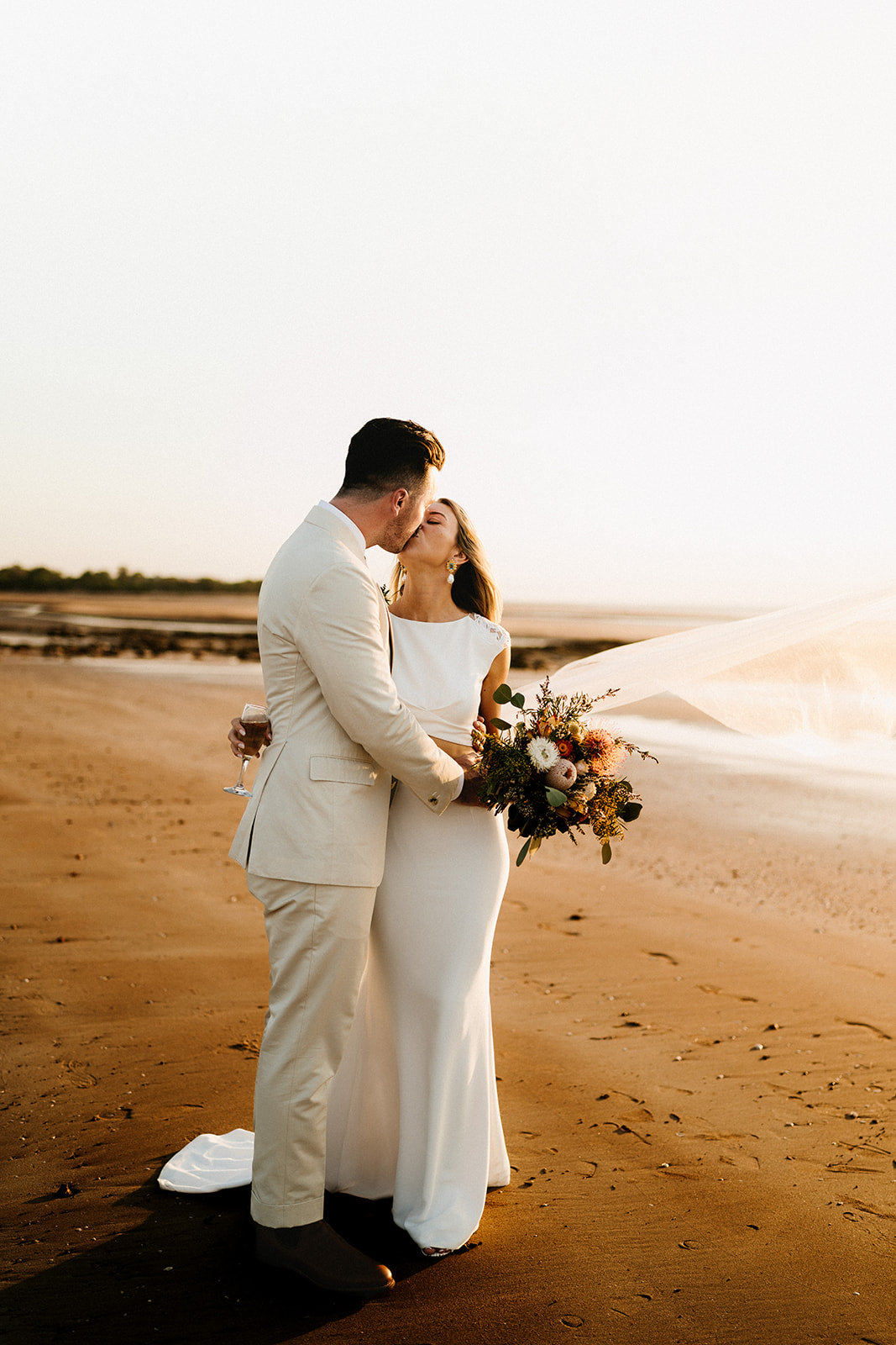 Hannah & Austin - Beija Flor Real Wedding - Bride and Groom kissing at the beach