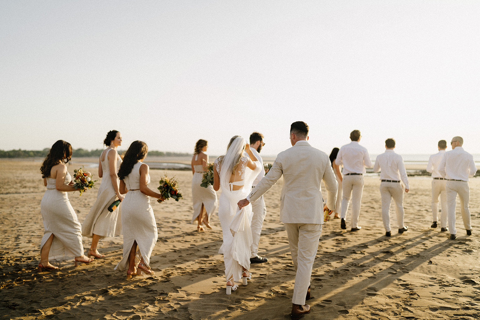 Hannah & Austin - Beija Flor Real Wedding - Bride Groom Bridesmaids and Goomsmen Walking at the Beach Side