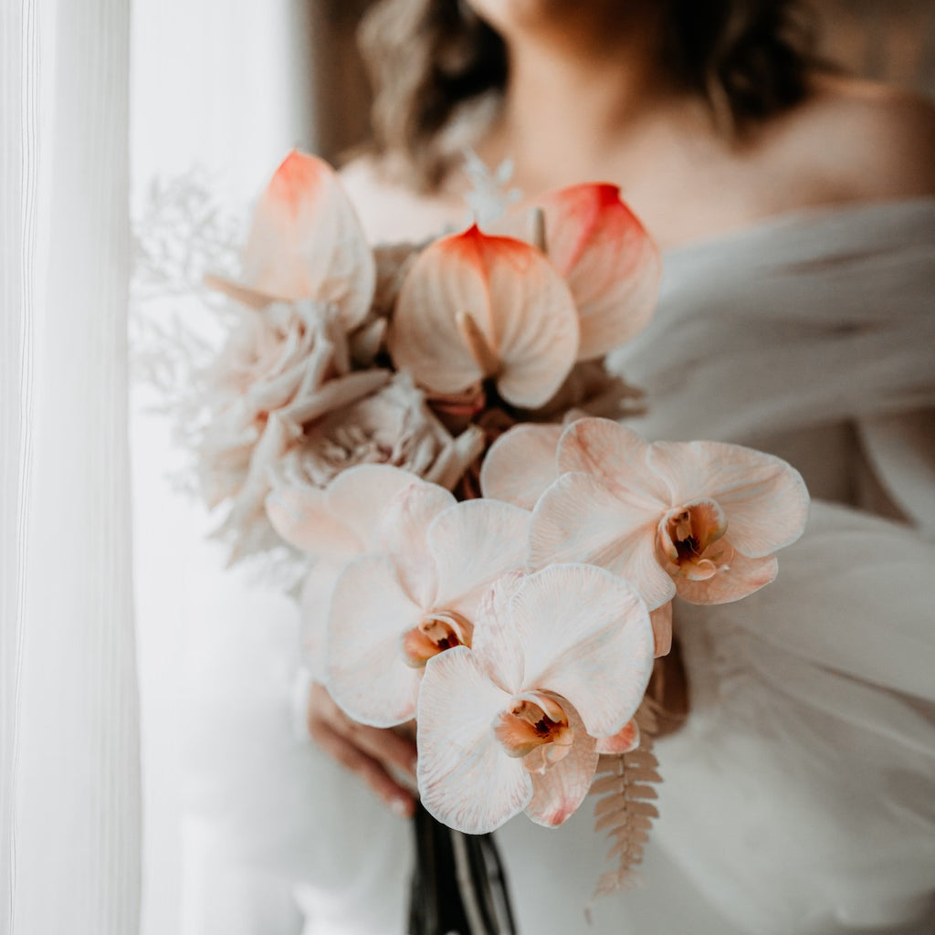 Lydia's wedding bouquet with peach-infused designs by Beija flor