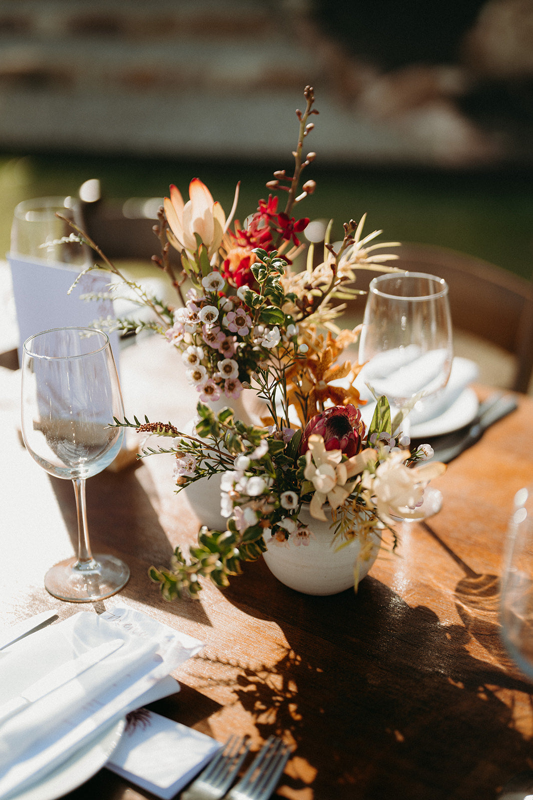 Naomi and Jack - Beija Flor Real Wedding - Table Florals with warm pink, red and native blooms