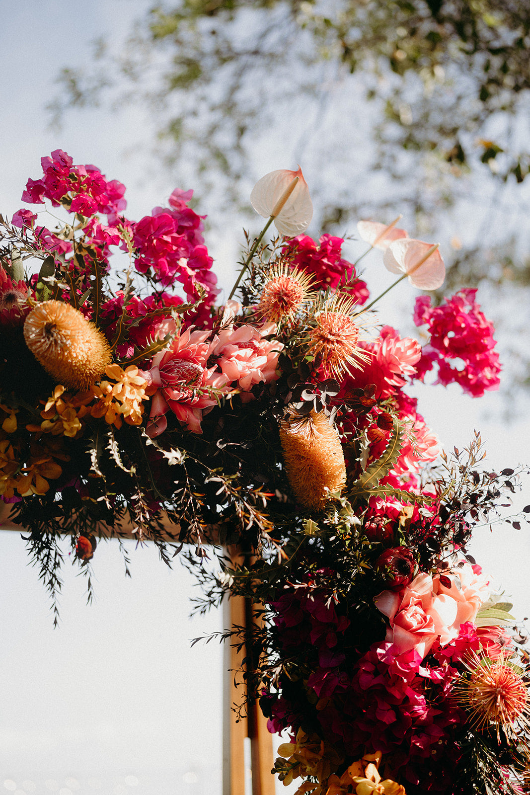 Naomi and Jack - Beija Flor Real Wedding - timber arbour, with floral in sunset shades