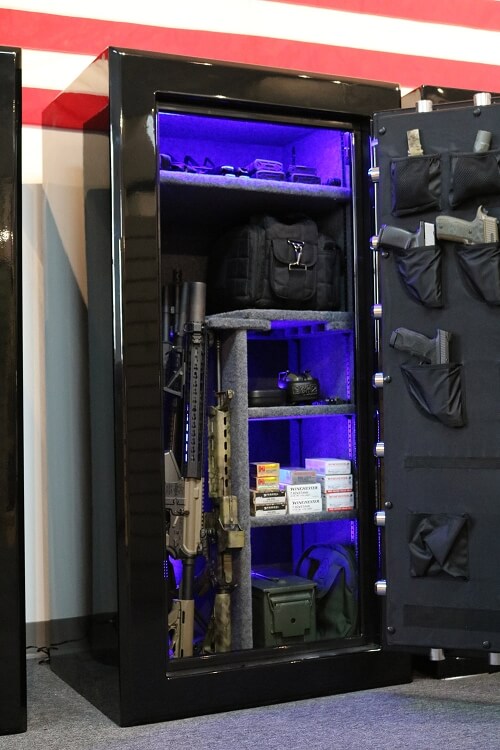 60 inch tall by 30 inch wide Old Glory gun safe loaded in gloss black unlocked with blue LED lights and door storage