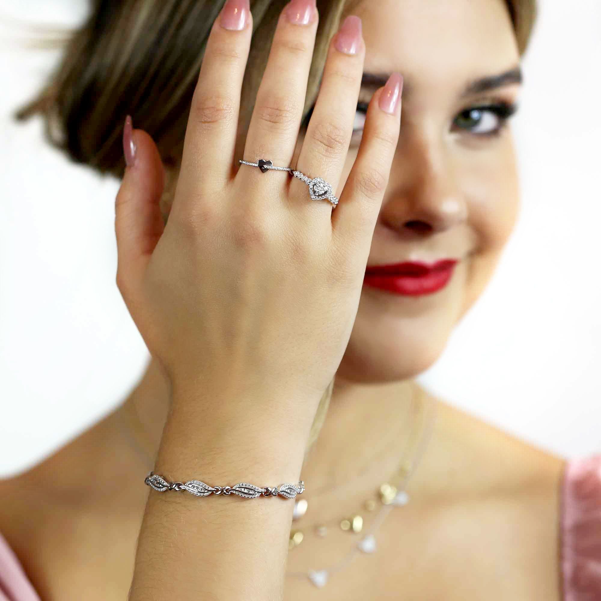 A woman with blonde hair wearing the At Last Diamond Bracelet from Steven Singer Jewelers