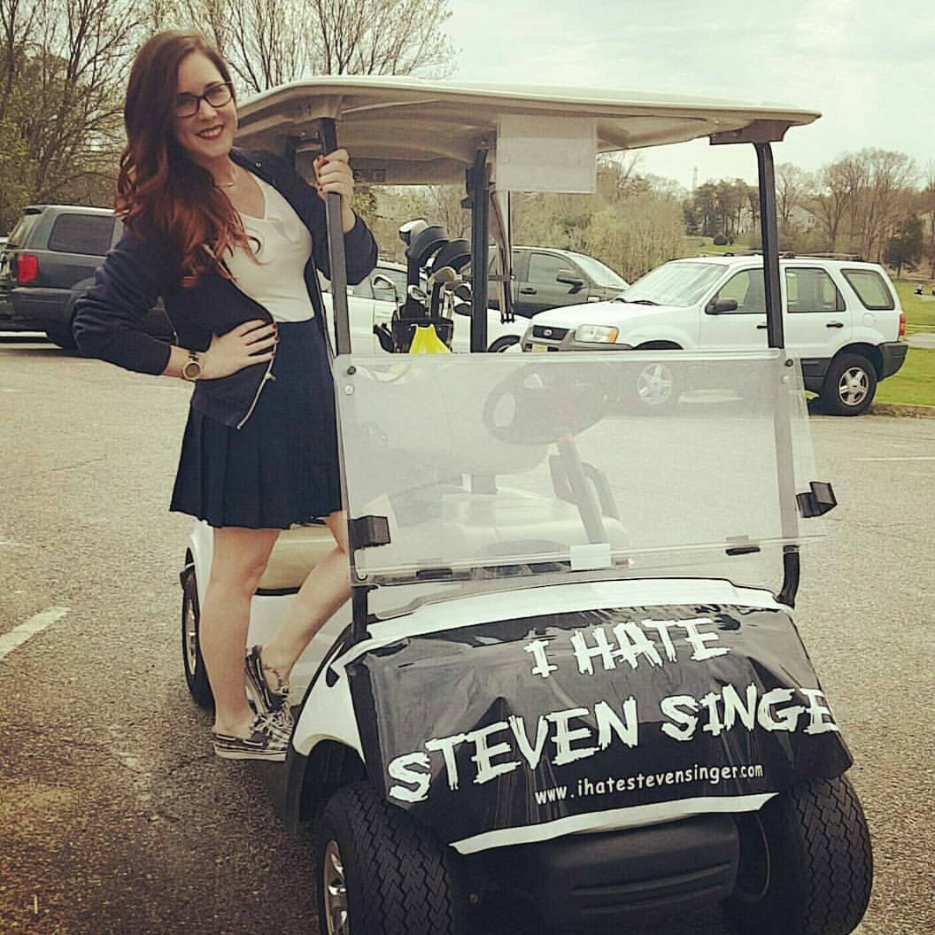 Ashley on a "I Hate Steven Singer" golf cart.