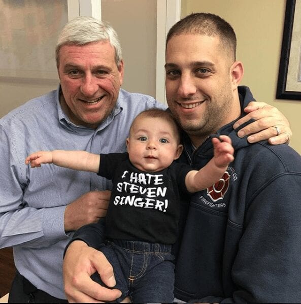 Bob with a customer and their son.