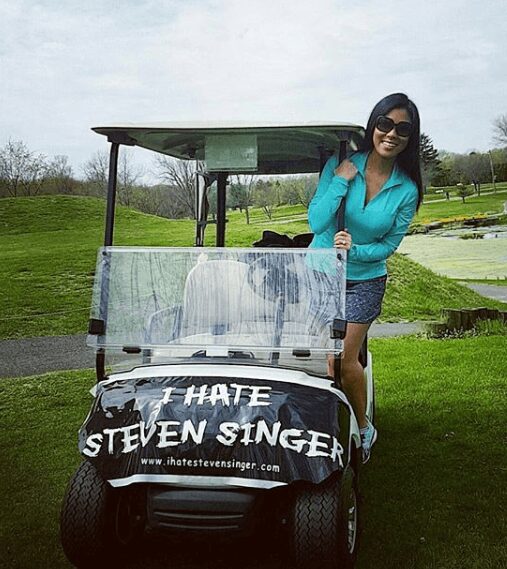 Stephanie on a golf cart with the "I Hate Steven Singer" slogan on it.