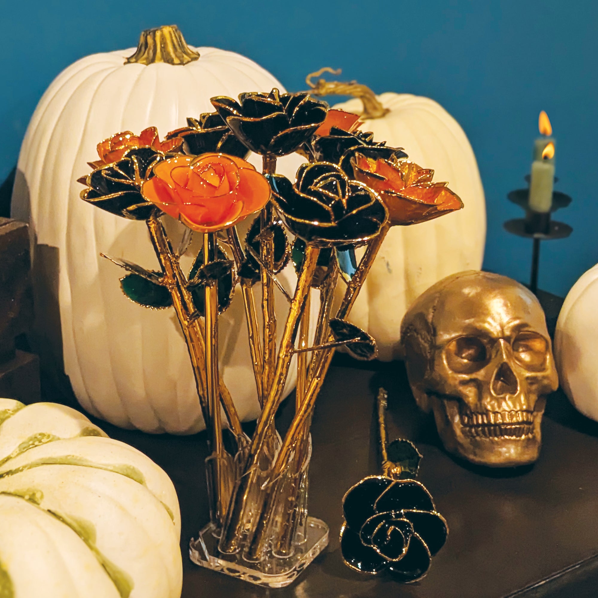 Steven Singer Jewelers' Creamsicle and Black Diamond Gold Dipped Roses pictured with Halloween decor.
