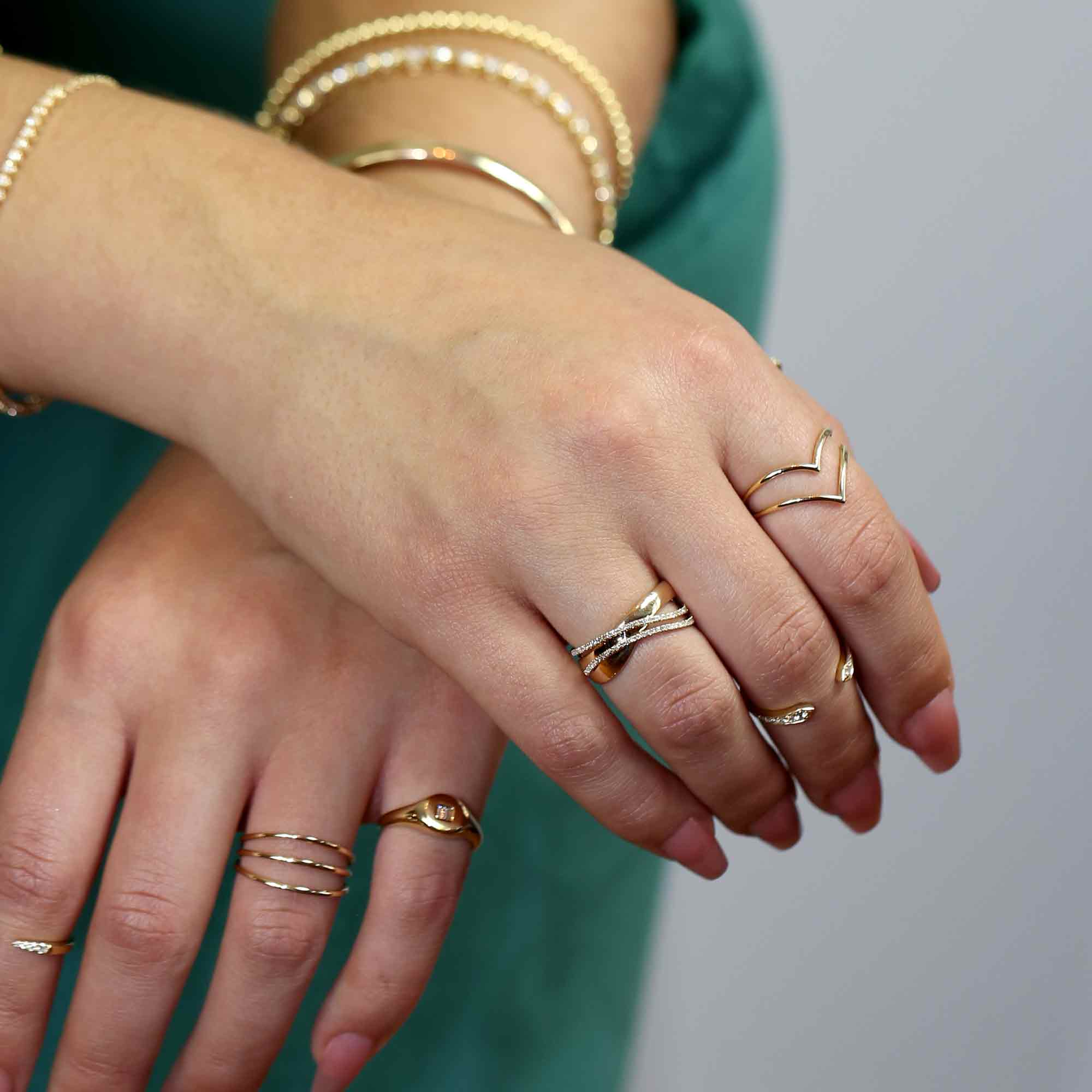 Hands wearing stackable rings on fingers