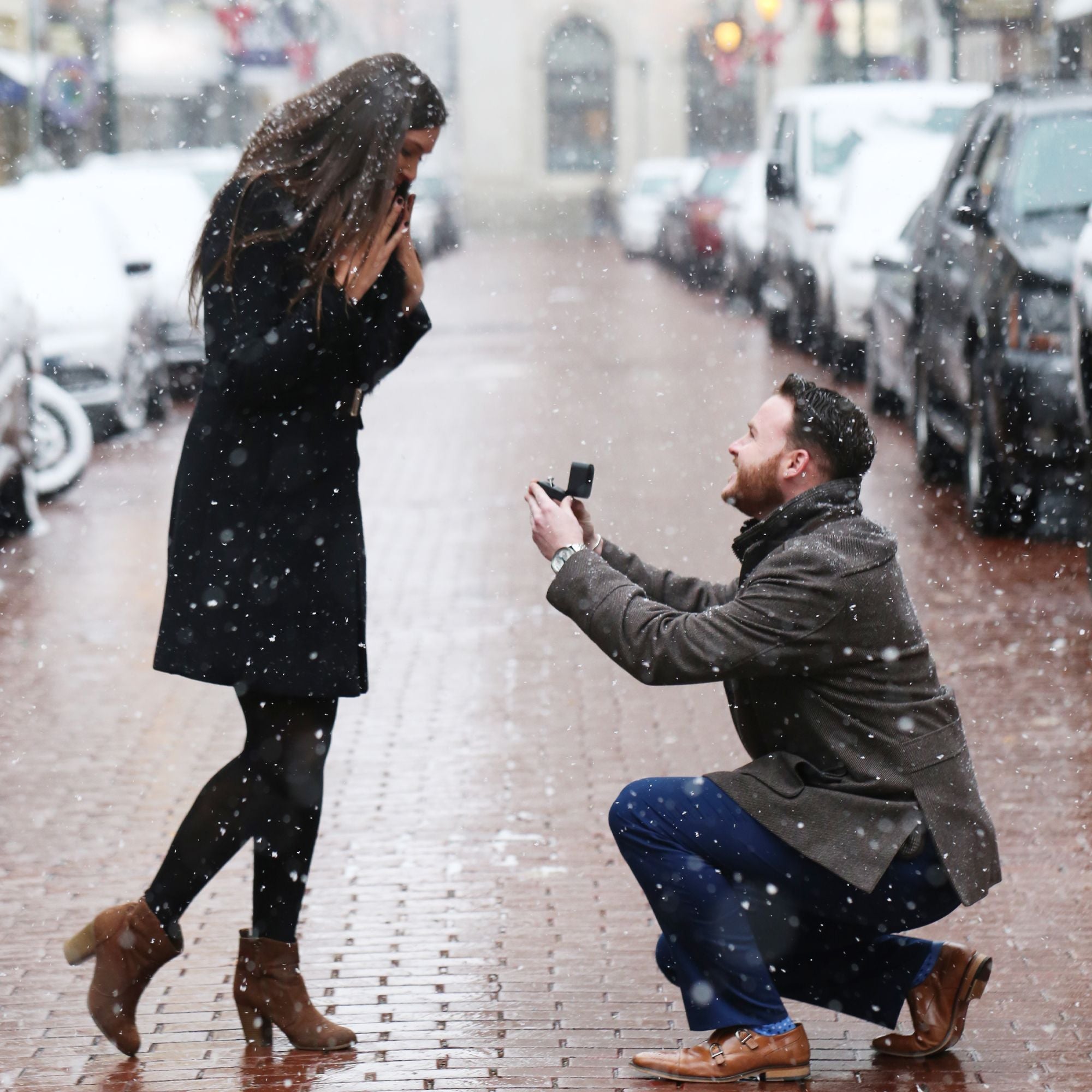 Romantic winter proposal while it's snowing