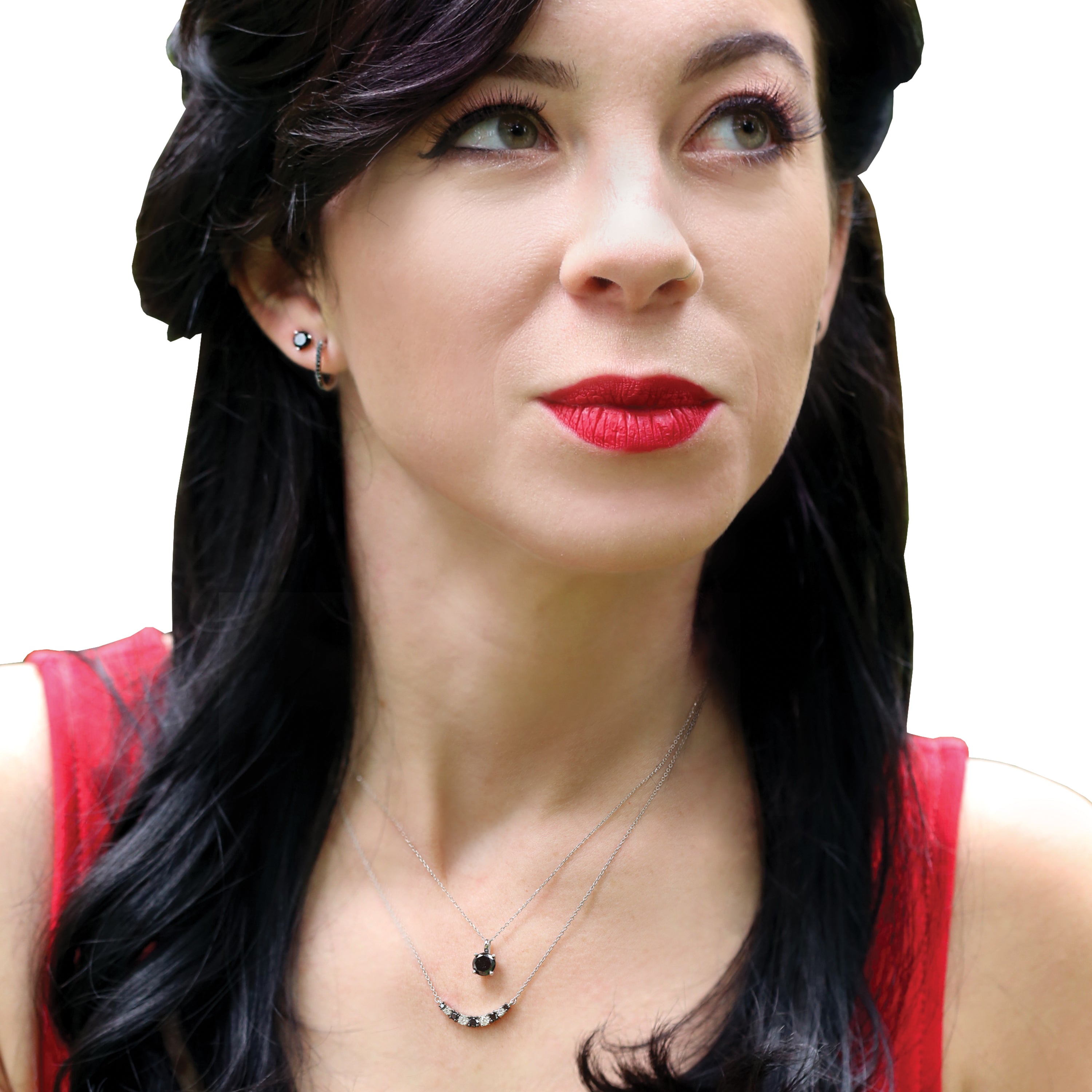 A woman wearing black diamond jewelry from Steven Singer Jewelers. Featured are black diamond studs, and the Salem black and white diamond necklace.