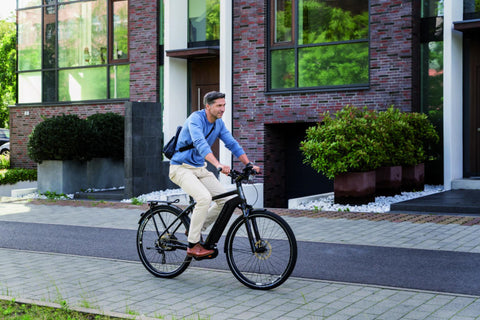 Man riding an electric bike in a residential area