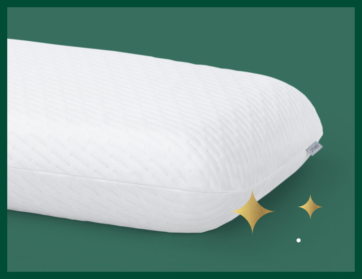 Half of the original foam pillow from Tuft & Needle. Picture has a green background with gold stars.