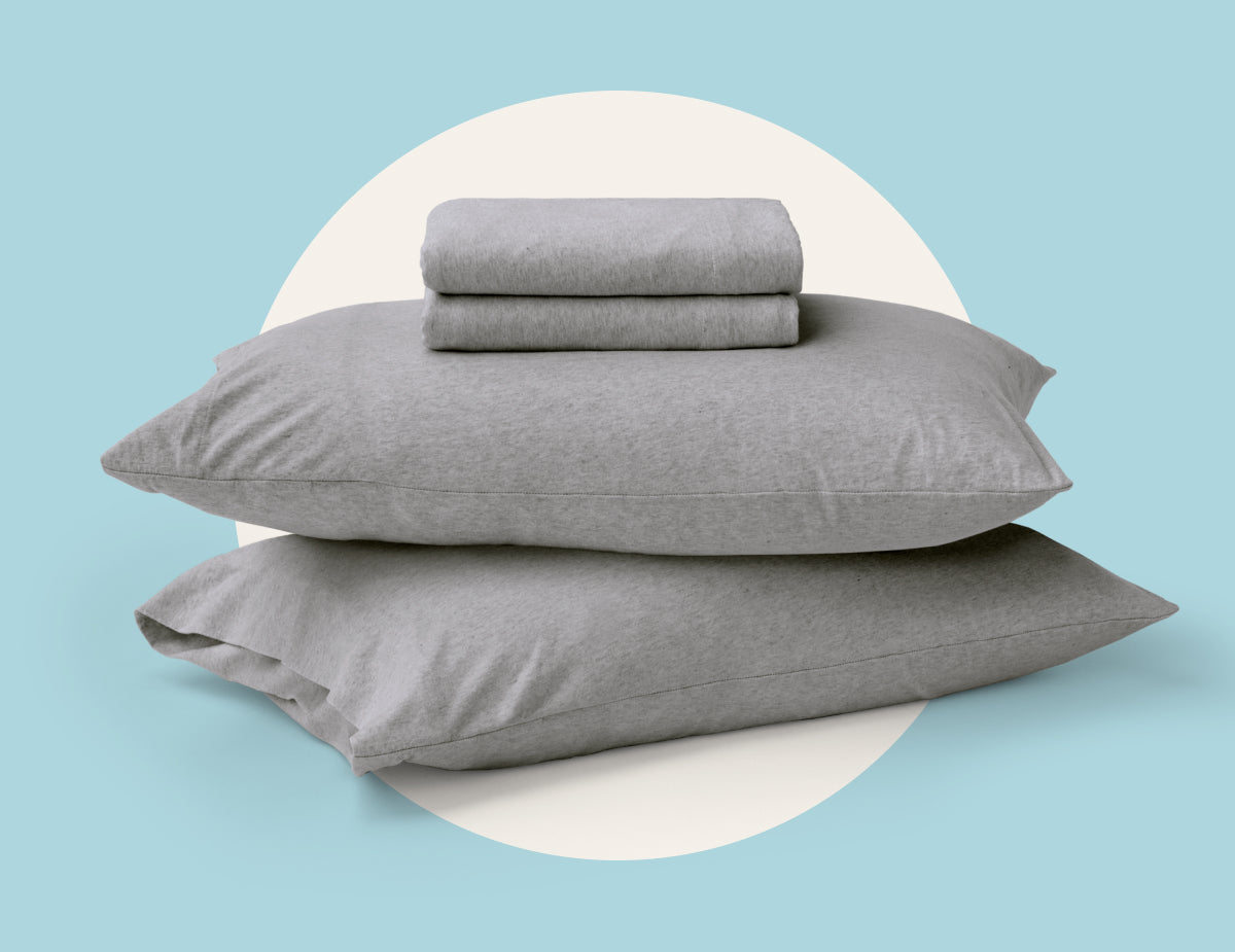 Picture two pillows with folded sheets on top of them by Tuft & Needle, a dorm room essential