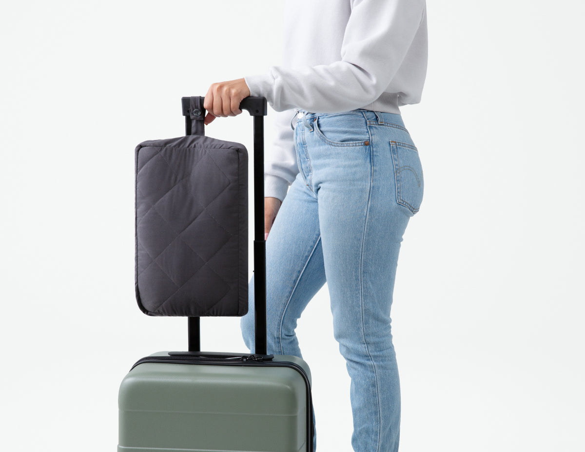 Side view of a woman pushing some luggage