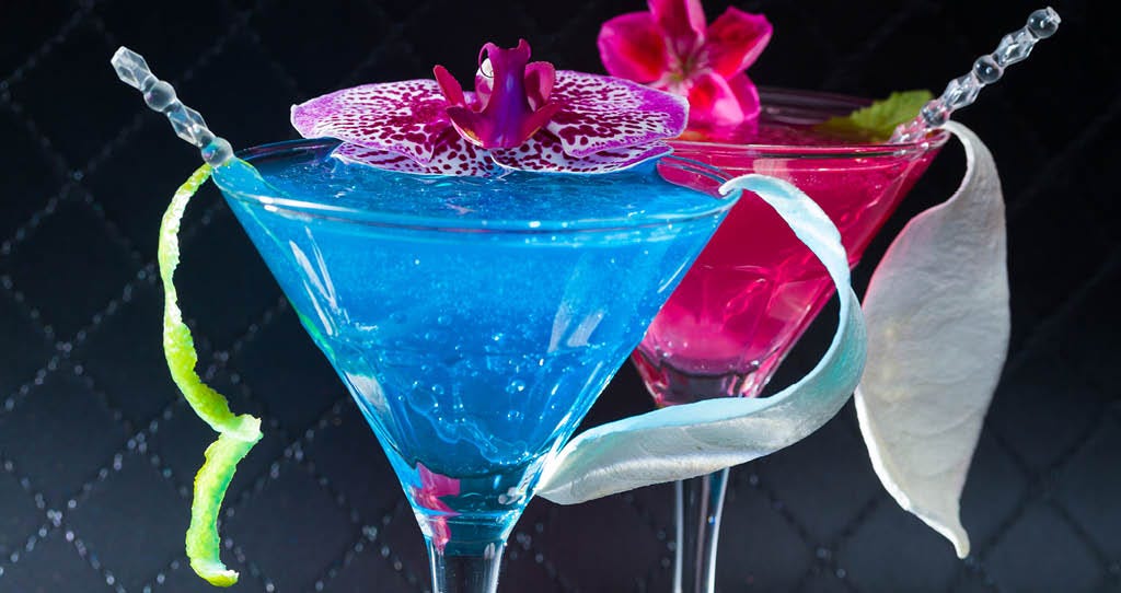 Blue and purple margaritas sit side by side