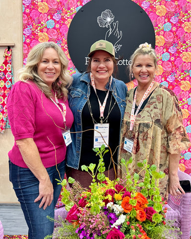 Jina Barney and Lori Woods of Poppie Cotton Fabrics, Chrissy Dunham of Good Vibes Quilt Shop at Quilt Market in Houston 2024