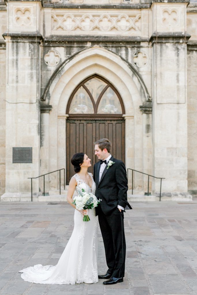 bride and groom by church