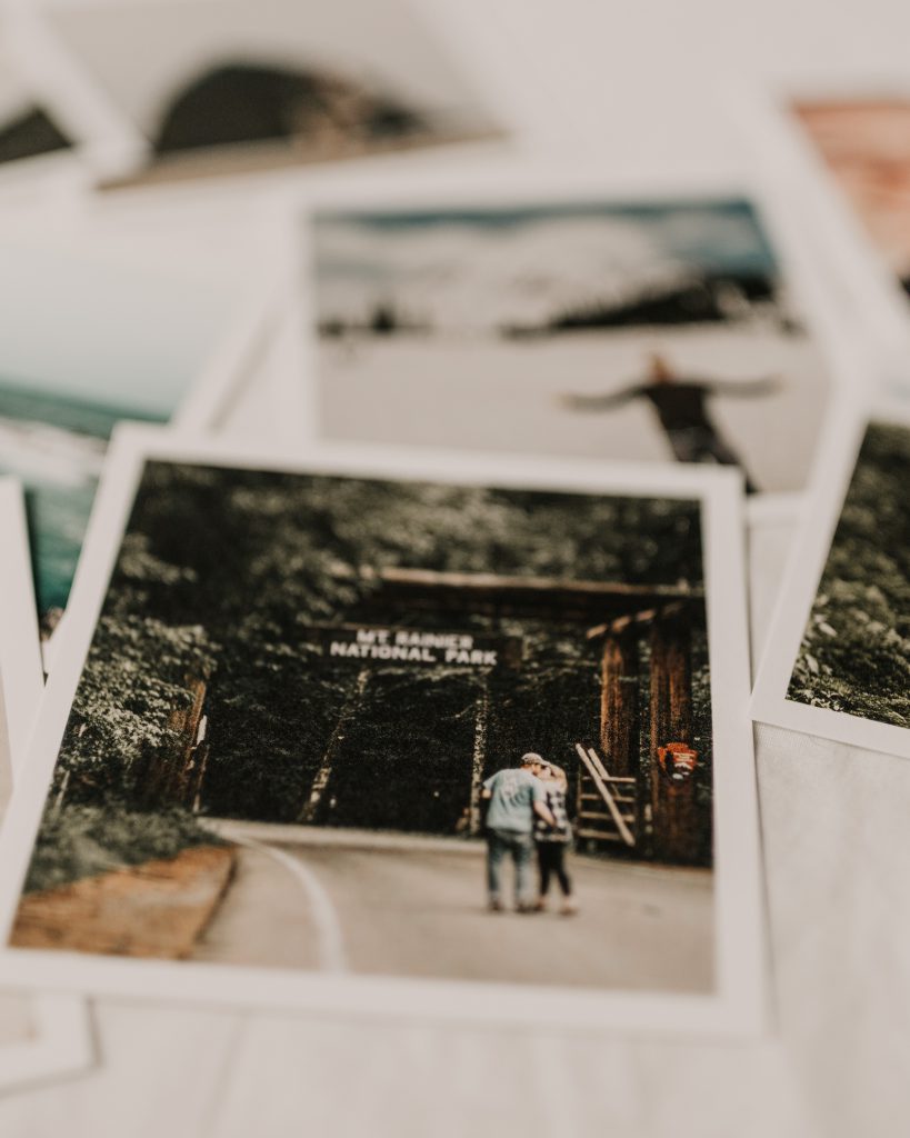 Photo prints stacked on table