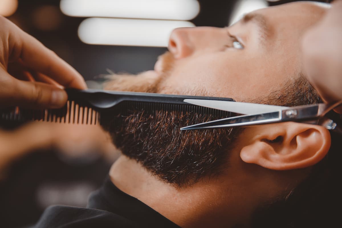 person having their beard trimmed