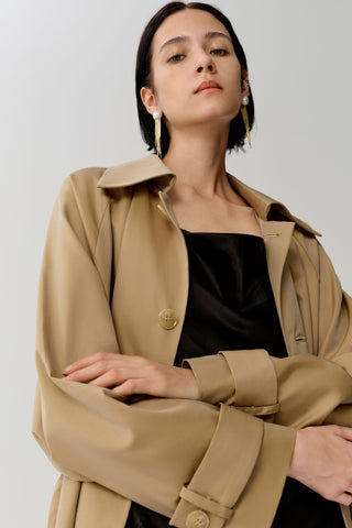 Woman in tan trench coat