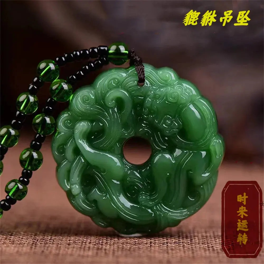 a green jade pendant with a black beaded cord