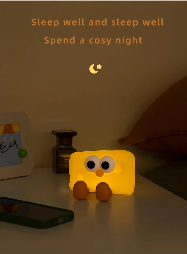 Cheese night light on a bedside table casting a soft glow