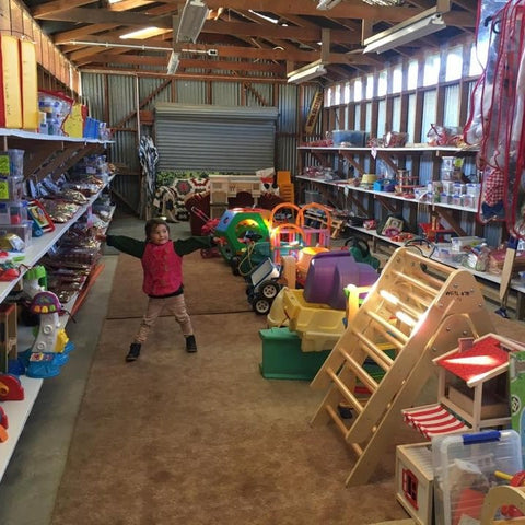 A child surrounded by toys at Wanaka Toy Library