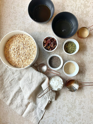 Ingredients for granola in bowls with a linen napkin