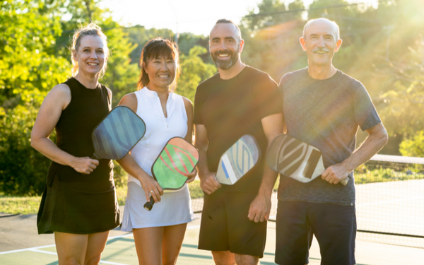 Friends with pickleball paddles