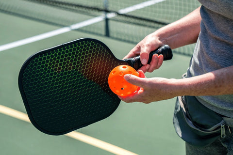 Pickleball Player Holding Paddle and Ball