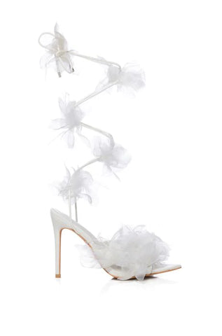 white open toe stiletto heels with wrap up cords and tulle flower accents