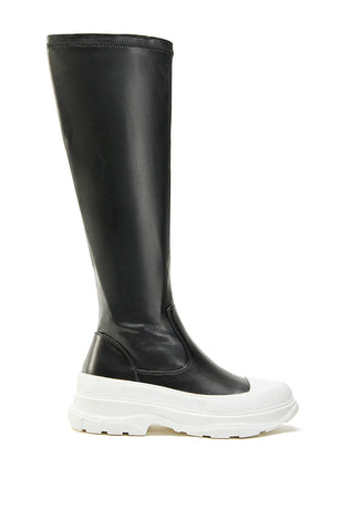 image of mid calf length black faux leather boots with a white platform sole