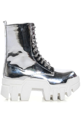 Metallic silver chrome platform combat boots with a white sole and lace-up silhouette