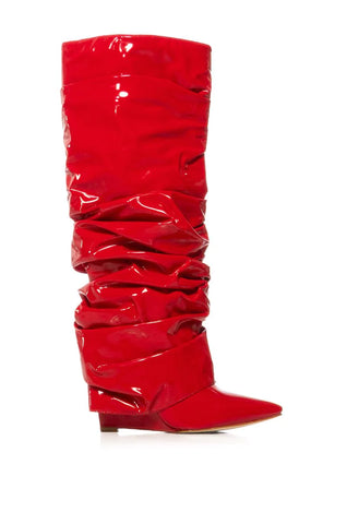 image of red knee high pointed toe boots made of patent leather with a wedge heel and scrunched fabric fold over boot silhouette