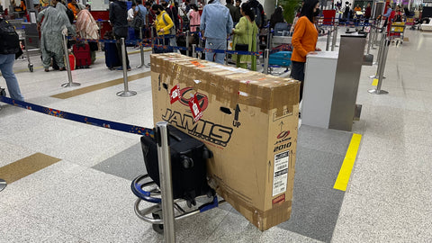 cardboard bike box on a luggage trolley at delhi airport