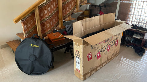 opened cardboard bike box in a house in india