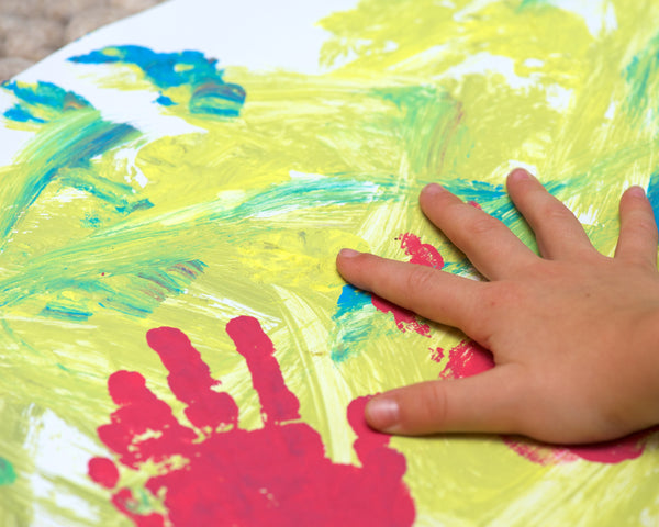 kid's hand shown painting